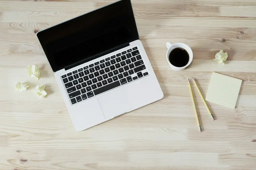 computer and coffee on table